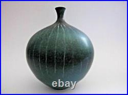 A Delan Cookson globular bottle vase. 17cm tall