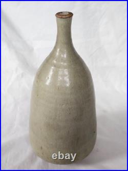 A tall celadon studio pottery sculptural vase, with potter's mark