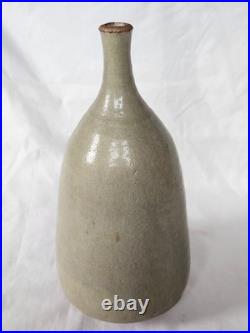 A tall celadon studio pottery sculptural vase, with potter's mark