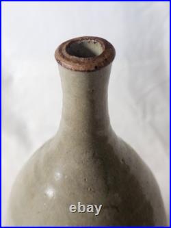 A tall celadon studio pottery sculptural vase, with potter's mark