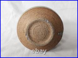 A tall celadon studio pottery sculptural vase, with potter's mark
