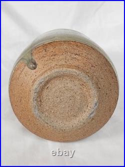 A tall celadon studio pottery sculptural vase, with potter's mark