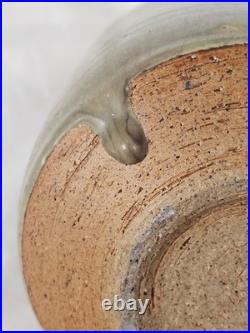 A tall celadon studio pottery sculptural vase, with potter's mark
