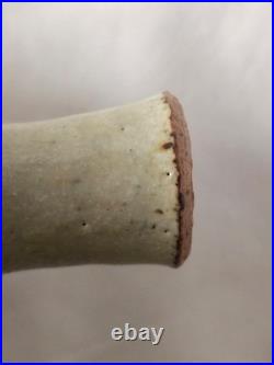 A tall celadon studio pottery sculptural vase, with potter's mark