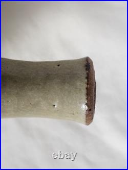 A tall celadon studio pottery sculptural vase, with potter's mark
