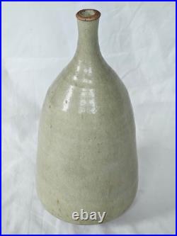 A tall celadon studio pottery sculptural vase, with potter's mark